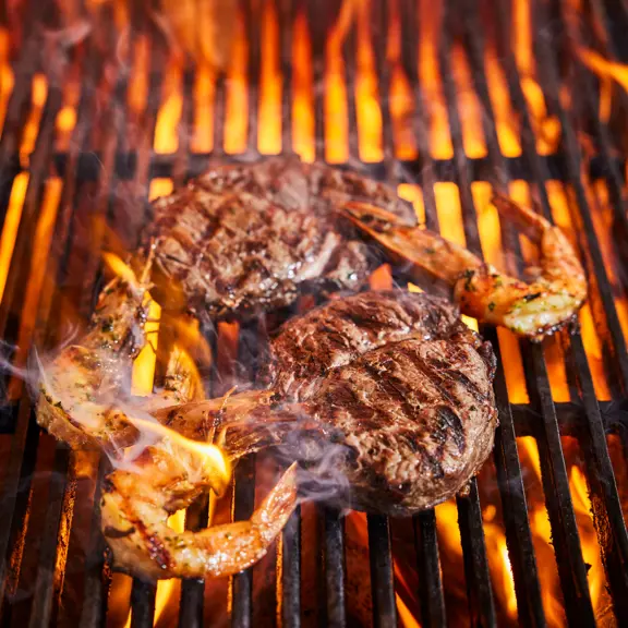 Prawns and Steak on a grill at SOUND London